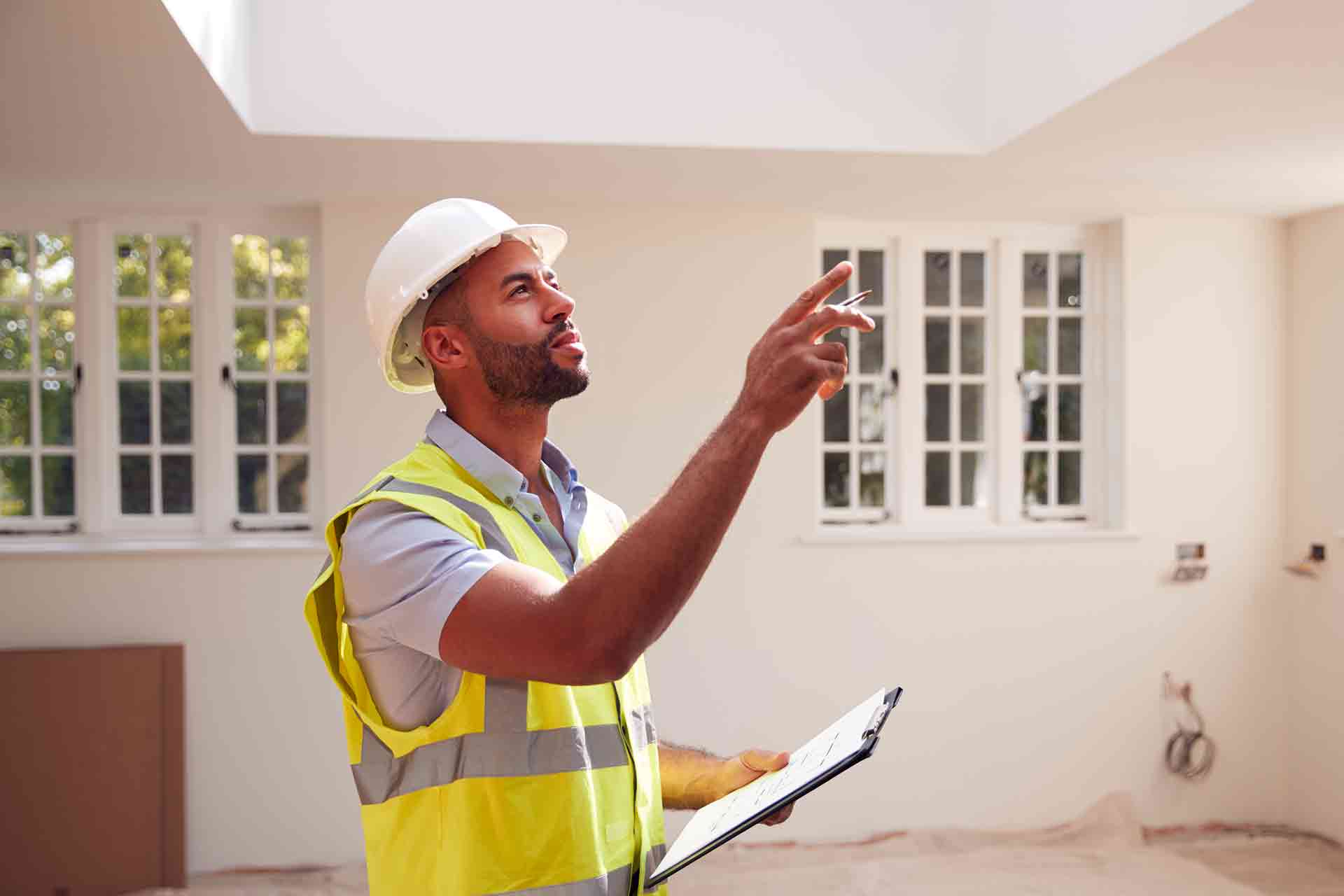 Third Party Wall Surveyors Epsom reviewing plans between two parties during a dispute
